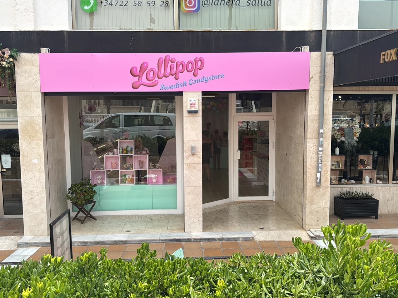 The Lollipop Swedish Candystore storefront with its pink sign in Orihuela Costa